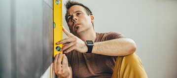 Man accessing house wall for adaptations